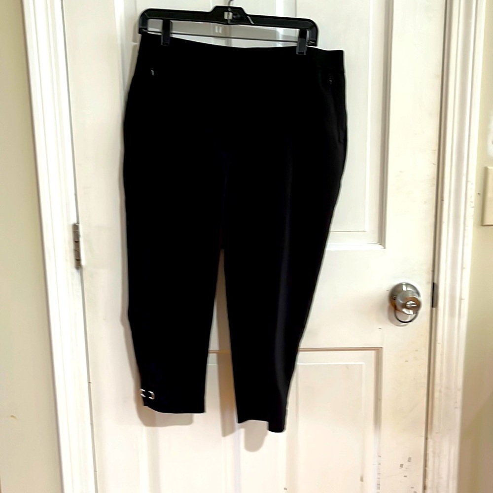 Black capri pants, size 8 petite & curvy. Bottom of leg of pant has silver